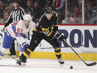 Boston Bruins Brad Marchand, left, knocks the stick out of Montreal Canadiens Max Pacioretty's hands as he pursue Bruins Zach Trotman during third period of National Hockey League game in Montreal Tuesday January 19, 2016.