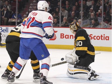 Boston Bruins Tuuka Rask makes a save as Montreal Canadiens Paul Byron waits for the rebound during first period of National Hockey League game in Montreal Tuesday January 19, 2016.