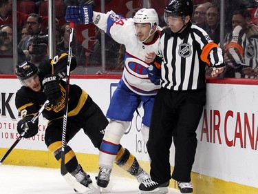 Montreal Canadiens Alexei Emelin collides with referee Marc Joannette while being pursued by Boston Bruins Kevan Miller during third period of National Hockey League game in Montreal Tuesday January 19, 2016.