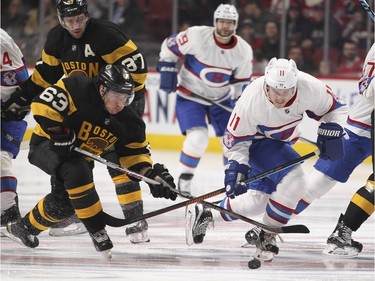 Montreal Canadiens Brendan Gallagher, #11, competes for loose puck with Boston Bruins Brad Marchand, #63, during first period of National Hockey League game in Montreal Tuesday January 19, 2016.