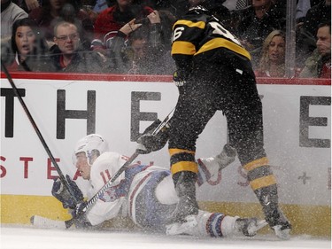 Montreal Canadiens Brendan Gallagher, is checked to the ice by Boston Bruins Kevan Miller during first period of National Hockey League game in Montreal Tuesday January 19, 2016.   Miller was penalized on the play.