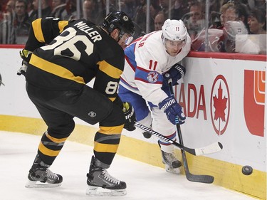 Montreal Canadiens Brendan Gallagher and Boston Bruins Kevan Miller fight for loose puck during first period of National Hockey League game in Montreal Tuesday January 19, 2016.
