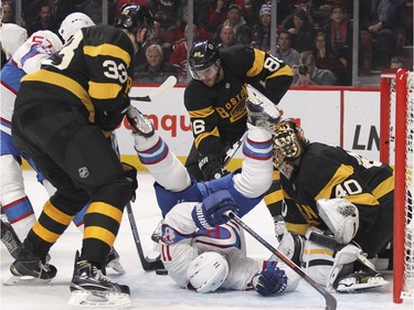 Montreal Canadiens Brendan Gallagher falls backwards in front of Boston Bruins goalie Tuuka Rask after being tripped by Zdeno Chara, left during third period of National Hockey League game in Montreal Tuesday January 19, 2016.  Bruins Kevan Millar looks for loose puck in background.