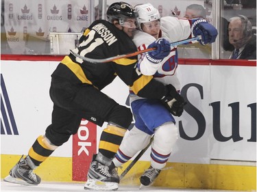 Montreal Canadiens Brendan Gallagher is held up by Boston Bruins Loui Eriksson in Montreal January 19, 2016.