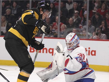 Montreal Canadiens goalie Mike Condon makes a glove save with Boston Bruins Loui Eriksson in his face during second period of National Hockey League game in Montreal Tuesday January 19, 2016.