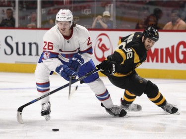 Montreal Canadiens Jeff Petry has his stick lifted off the puck by Boston Bruins Zac Rinaldo during second period of National Hockey League game in Montreal Tuesday January 19, 2016.