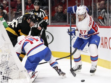 Montreal Canadiens Max Pacioretty grabs loose puck as Boston Bruins Kevan Miller ties up Habs Brendan Gallagher behind the Bruins net during first period of National Hockey League game in Montreal Tuesday January 19, 2016.