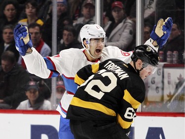 Montreal Canadiens Max Pacioretty appeals to the referee after having his stick knocked out of his hands by Boston Bruins Brad Marchand during third period of National Hockey League game in Montreal Tuesday January 19, 2016.  Bruins Zach Trotman blocks Pacioretty's path to the official.