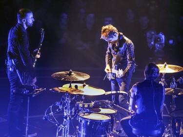 Muse, bass player Chris Wolstenholme, left, guitarist and vocalist Matt Bellamy and drummer Dominic Howard in concert at the Bell Centre in Montreal Wednesday January 20, 2016.