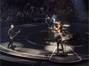 Muse presents their concert-in-the-round at the Bell Centre in Montreal Wednesday January 20, 2016. Bass player Chris Wolstenholme, left, drummer Dominic Howard and guitarist/vocalist Matt Bellamy.