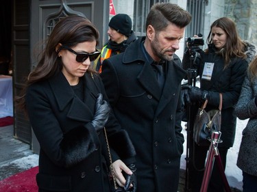 Anne-Marie Angélil, left, daughter of René Angélil, and husband Marc Dupré, right, who was managed by René, exit the cathedral after paying their respects to René Angélil, pop star Céline Dion's husband and manager, Thursday January 21, 2016 at the Notre Dame Basilica in Montreal. Angélil died of cancer January 14, 2016 and was lying in state Thursday before his funeral Friday.