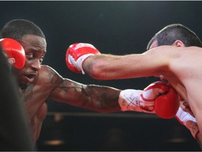 Custio Clayton of Montreal, left, hits Stanislas Salmon of France during boxing event at the Casino de Montréal, Thursday January 21, 2016. Clayton won the fight with a second round TKO.