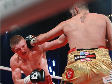 Erik Bazinyan, right, of Laval hits Michal Ludwiczak of Poland during boxing event at the Casino de Montréal, Thursday January 21, 2016.
