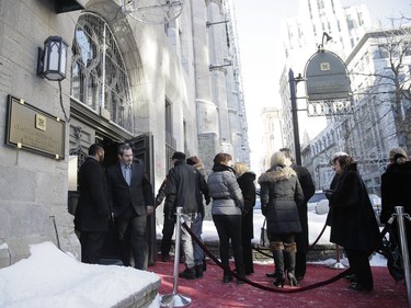 Mourners line up to pay their respects to René Angélil, pop star Céline Dion's husband and manager, Jan. 9, 2016, at Notre Dame Basilica in Montreal.