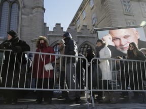 Mourners line up to pay their respects to René Angélil, pop star Céline Dion's husband and manager, Thursday January 21, 2016 at the Notre Dame Basilica in Montreal. Angélil died of cancer January 14, 2016 and was lying in state Thursday before his funeral Friday.
