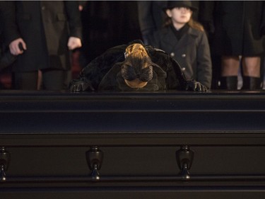 Céline Dion kisses the casket that holds her husband René Angélil, behind her are her sons René-Charles, twins Nelson and Eddy, along with more family, at  Notre Dame Basilica, in Montreal, Friday January 22, 2016.