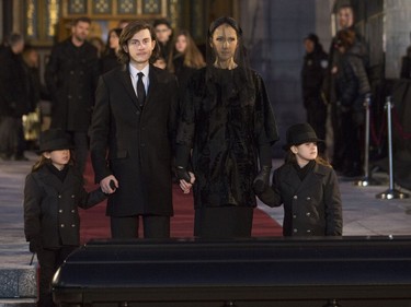 Céline Dion with her  sons  René-Charles, to her right and twins Nelson and Eddy stand before the casket after the funeral for husband and father,  René Angélil, at Notre Dame Basilica, in Montreal, Friday January 22, 2016.