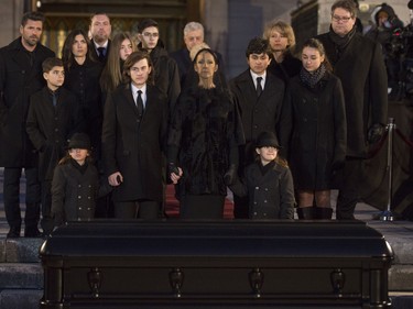 Céline Dion with her  sons  René-Charles, to her right and twins Nelson and Eddy, along with more family,  stand before the casket after the funeral for husband and father,  René Angélil, at Notre Dame Basilica, in Montreal, Friday January 22, 2016.