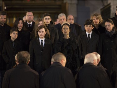 Céline Dion with her  sons  René-Charles, to her right and twins Nelson and Eddy, along with more family, stand before the casket after the funeral for husband and father,  René Angélil, at Notre Dame Basilica, in Montreal, Friday January 22, 2016.