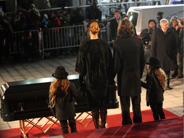 Singer Céline Dion, stands with her three  sons, Nelson, René-Charles and Eddy, in front of her husband René Angélil's coffin during his funeral at Montreal's Notre-Dame Basilica on Friday Jan. 22, 2016.