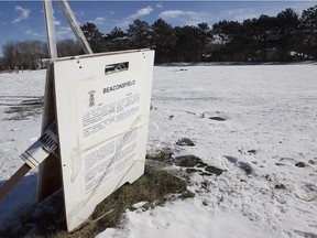 A city notice on the lot of former site of an Esso gas station at 100 Beaurepaire Drive in Beaconsfield on Saturday January 23, 2016. The town is looking to rezone the area to allow for the construction of townhouses. (Pierre Obendrauf / MONTREAL GAZETTE)