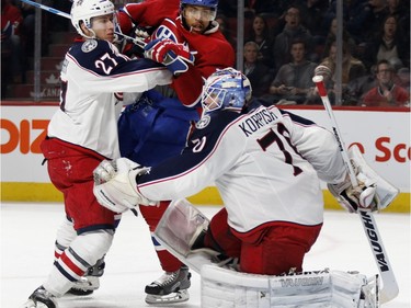 Columbus Blue Jackets defenceman Ryan Murray, left, pushes Montreal Canadiens right wing Devante Smith-Pelly away from Columbus Blue Jackets goalie Joonas Korpisalo during NHL action at the Bell Centre in Montreal on Tuesday January 26, 2016.