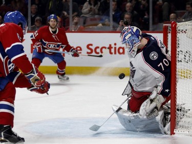 Columbus Blue Jackets goalie Joonas Korpisalo, stops a shot by Montreal Canadiens left wing Max Pacioretty during NHL action at the Bell Centre in Montreal on Tuesday January 26, 2016. Montreal Canadiens centre David Desharnais, second from left, looks on.