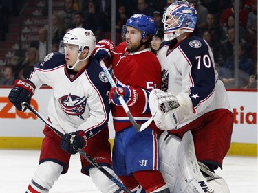 Columbus Blue Jackets goalie Joonas Korpisalo, right pushes Montreal Canadiens centre David Desharnais in to Columbus Blue Jackets defenceman Ryan Murray during NHL action at the Bell Centre in Montreal on Tuesday January 26, 2016.