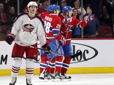 Columbus Blue Jackets left wing Brandon Saad, left, skates away as Montreal Canadiens defenceman Nathan Beaulieu and Montreal Canadiens left wing Jacob De La Rose celebrate scoring against Columbus Blue Jackets goalie Joonas Korpisalo during NHL action at the Bell Centre in Montreal on Tuesday January 26, 2016.