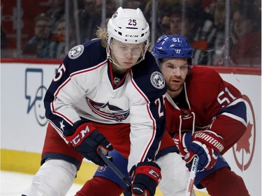 Montreal Canadiens centre David Desharnais, right, tries to tie up Columbus Blue Jackets centre William Karlsson during NHL action at the Bell Centre in Montreal on Tuesday January 26, 2016.