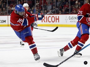 Montreal Canadiens defenceman P.K. Subban, centre, takes a shot at net as Montreal Canadiens right wing Dale Weise, left, and Columbus Blue Jackets centre Gregory Campbell look on during NHL action at the Bell Centre in Montreal on Tuesday January 26, 2016.