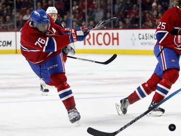 Montreal Canadiens defenceman P.K. Subban, centre, takes a shot at net as Montreal Canadiens right wing Dale Weise, left, and Columbus Blue Jackets centre Gregory Campbell look on during NHL action at the Bell Centre in Montreal on Tuesday January 26, 2016.