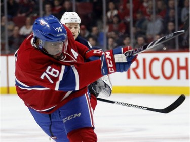 Montreal Canadiens defenceman P.K. Subban, centre, takes a shot at net as Montreal Canadiens right wing Dale Weise, left, and Columbus Blue Jackets centre Gregory Campbell look on during NHL action at the Bell Centre in Montreal on Tuesday January 26, 2016.