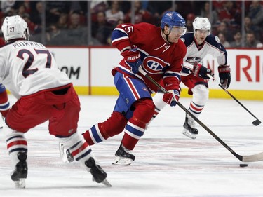 Montreal Canadiens left wing Tomas Fleischmann looks for a chance to shoot on net as he skates between Columbus Blue Jackets defenceman Ryan Murray, left, and Columbus Blue Jackets left wing Brandon Saad during NHL action at the Bell Centre in Montreal on Tuesday January 26, 2016.
