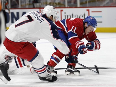Montreal Canadiens right wing Brendan Gallagher, right, grimaces as he is hit by Columbus Blue Jackets defenceman Jack Johnson during NHL action at the Bell Centre in Montreal on Tuesday January 26, 2016.