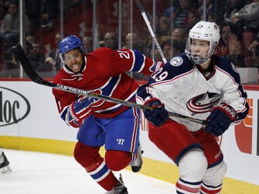 Montreal Canadiens right wing Devante Smith-Pelly, left, scrambles to catch Columbus Blue Jackets defenceman Cody Goloubef after being checked by Goloubef during NHL action at the Bell Centre in Montreal on Tuesday January 26, 2016.