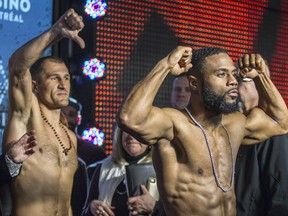 Champion Sergey Kovalev, left, gives thumbs-down on Friday to challenger Jean Pascal during weigh-in for their bout Saturday night at the Bell Centre.