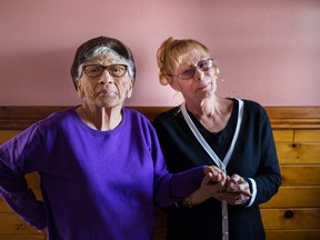 Dolores Montour, left, poses for a photograph with her friend Georgina White at her home in Kahnawake, on Tuesday, January 5, 2016. The two mothers became friends after the White's son, Derek Beauvais, shot and killed his friend Conrad Delisle, Montour's son, during a fight in 2012.