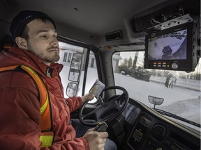 Michael Vanasse, driver for Services Matrec, watches video screen as he aligns his pickup forks with a garbage bin in Beaconsfield on Thursday, January 7, 2016. (Peter McCabe / MONTREAL GAZETTE)