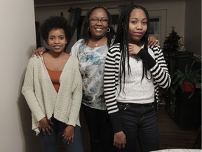 Martine Augustin (centre), with daughters Limartine (left) and Leila in Laval.