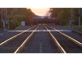 A freight train crosses over commuter tracks in Barrington, Ill., which has recently seen a sharp increase in rail traffic. When village president Karen Darch visited Lac-Mégantic after the July 2013 disaster, she was struck by how much it had in common with Barrington — the busy pub by the tracks, the way the sunset turns the rails red. She is calling for stricter safety standards.