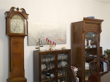 A grandfather clock stands among other antiques at the home of Barbara Asgary.  (Phil Carpenter / MONTREAL GAZETTE).