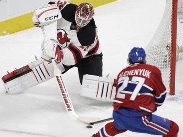 Alex Galchenyuk of the Montreal Canadiens tries to get the puck from New Jersey Devils goalie Cory Schneider in the first period at the Bell Centre in Montreal on Wednesday, Jan. 6, 2016.
