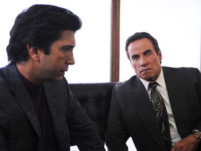 In this image released by FX, David Schwimmer portrays Robert Kardashian, left, and John Travolta portrays Robert Shapiro, in a scene from The People v. O.J. Simpson: American Crime Story" a 10-part series debuting Tuesday, Feb. 2, at 10 p.m. EST Tuesday.  (Ray Mickshaw/FX via AP)