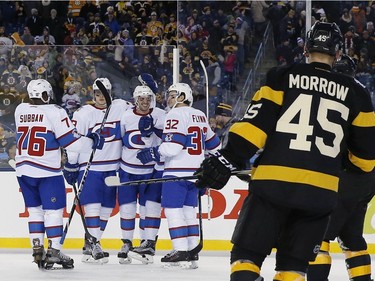 Montreal Canadiens players, including P.K. Subban (76) and Brian Flynn (32) celebrate a goal by teammate Paul Byron, hidden right, during the third period of the NHL Winter Classic hockey game against the Boston Bruins at Gillette Stadium in Foxborough, Mass., Friday, Jan. 1, 2016.