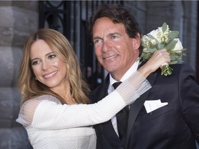Parti Quebecois Leader Pierre-Karl Peladeau and Julie Snyder hug after getting married, Saturday, Aug. 15, 2015 in Quebec City.