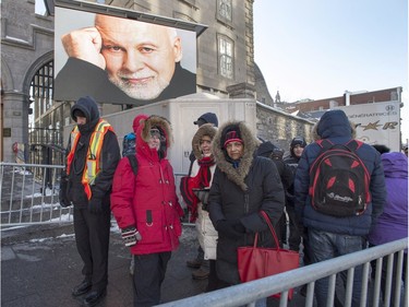 People line up to pay their respects at the visitation for René Angelil, husband of singer Céline Dion, at Notre-Dame Basilica Jan. 21, 2016, in Montreal.