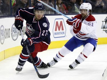 Columbus Blue Jackets' Ryan Murray, left, handles the puck against Montreal Canadiens' David Desharnais during the first period of an NHL hockey game in Columbus, Ohio,  Monday, Jan. 25, 2016.