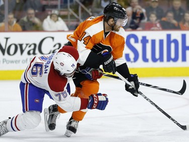 Montreal Canadiens' P.K. Subban, left, collides with Philadelphia Flyers' Sean Couturier during the second period of an NHL hockey game, Tuesday, Jan. 5, 2016, in Philadelphia.