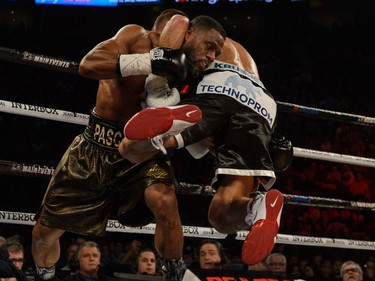 Sergey Kovalev of Russia grabs Jean Pascal of Laval in a headlock during the WBO, WBA, and IBF light-heavyweight world championship match at the Bell Centre on January 30, 2016.